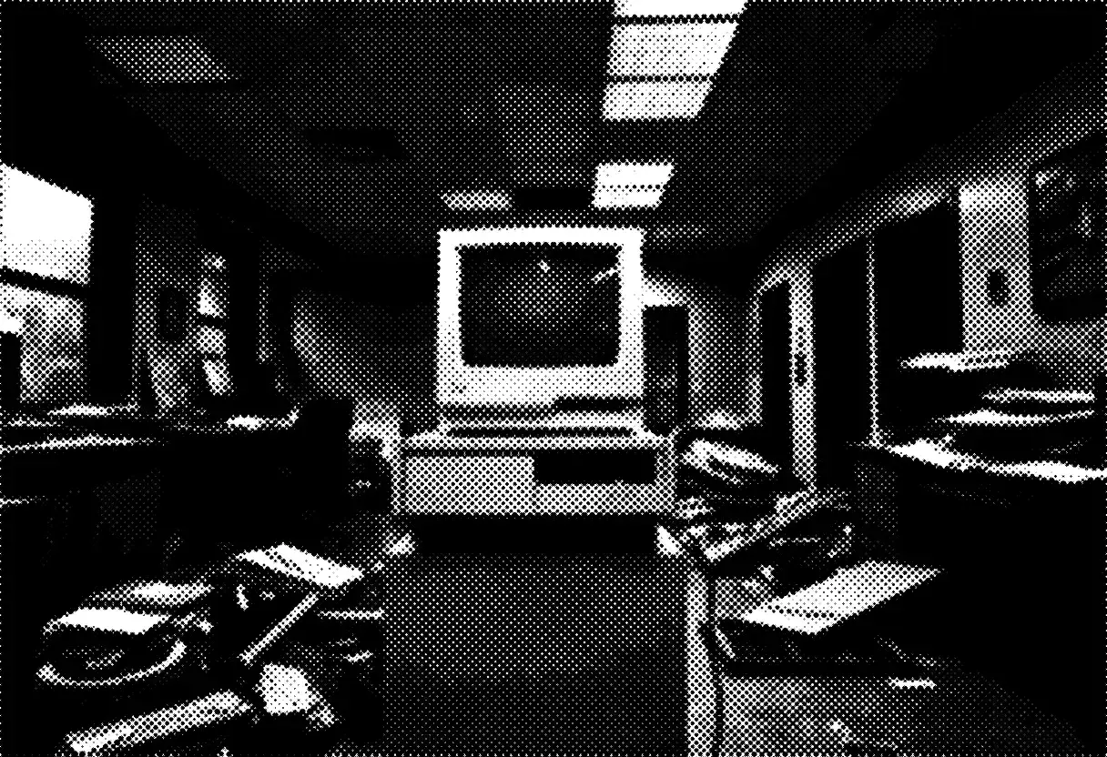 Newspaper halftone photo: an old computer terminal stands untouched in a wrecked office, its prompt still lit